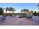 An outdoor patio with seating, a grill, and lush landscaping at 4188 Muirfield Loop, Lake Wales, FL 33859