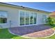 A beautiful brick patio with a sliding glass door offers seamless indoor/outdoor living and backyard views at 4188 Muirfield Loop, Lake Wales, FL 33859
