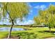 Scenic pond view with shaded gazebos and lush green grass, perfect for relaxation at 4188 Muirfield Loop, Lake Wales, FL 33859