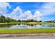 Picturesque view of the golf course pond with a reflection of the sky and trees at 4188 Muirfield Loop, Lake Wales, FL 33859