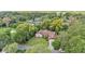 Aerial view of the home in a wooded neighborhood showcasing its spacious lot and mature trees at 4219 Forest Hills Dr, Lakeland, FL 33813