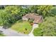 An aerial view of the property featuring a spacious lawn, mature landscaping, and convenient carport at 4219 Forest Hills Dr, Lakeland, FL 33813