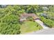 An aerial view of the property featuring a spacious lawn, mature landscaping and attached carport at 4219 Forest Hills Dr, Lakeland, FL 33813