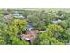 Aerial view of the home in a wooded neighborhood showcasing its spacious lot and mature trees at 4219 Forest Hills Dr, Lakeland, FL 33813