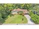 An aerial view of the property featuring a spacious lawn, mature landscaping and attached carport at 4219 Forest Hills Dr, Lakeland, FL 33813