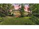 View of a beautiful home featuring a manicured lawn and mature trees creating a private backyard at 4219 Forest Hills Dr, Lakeland, FL 33813