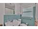 Well-maintained bathroom featuring blue tile, a pedestal sink, and a frosted glass window for privacy at 4219 Forest Hills Dr, Lakeland, FL 33813