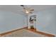 Light blue bedroom boasts ceiling fan, closet, and hardwood floors at 4219 Forest Hills Dr, Lakeland, FL 33813