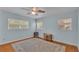 Bright bedroom features three windows, ceiling fan, and area rug at 4219 Forest Hills Dr, Lakeland, FL 33813
