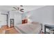 This bedroom features a ceiling fan, wooden floors, and a closet for ample storage space at 4219 Forest Hills Dr, Lakeland, FL 33813