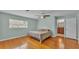 Bedroom featuring hardwood floors, fan, and bathroom access at 4219 Forest Hills Dr, Lakeland, FL 33813