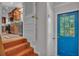 Inviting entryway with tile stairs and a bright blue front door that offers natural light at 4219 Forest Hills Dr, Lakeland, FL 33813