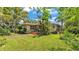 Charming single-story home with a well-manicured lawn and vibrant landscaping at 4219 Forest Hills Dr, Lakeland, FL 33813