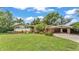 Charming single-story home featuring a well-maintained lawn, carport, and inviting curb appeal at 4219 Forest Hills Dr, Lakeland, FL 33813