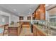 Spacious kitchen boasting granite countertops, wooden cabinets, and stainless-steel sink at 4219 Forest Hills Dr, Lakeland, FL 33813