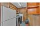 Functional laundry room featuring wood-paneled walls and a washer and dryer at 4219 Forest Hills Dr, Lakeland, FL 33813