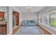 Bright living room with hardwood floors, a large window, and a comfortable sofa, perfect for relaxation at 4219 Forest Hills Dr, Lakeland, FL 33813