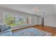 Airy living room boasting hardwood floors, a large window, and stylish decor, ideal for entertaining at 4219 Forest Hills Dr, Lakeland, FL 33813