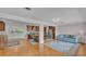 Open-concept living room featuring hardwood floors, a stylish area rug, and seamless access to the kitchen at 4219 Forest Hills Dr, Lakeland, FL 33813