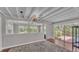 Bright living room featuring wooden flooring, chandelier, and large glass sliding doors at 4219 Forest Hills Dr, Lakeland, FL 33813