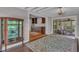 Bright living room featuring wooden flooring, chandelier, and large glass sliding doors at 4219 Forest Hills Dr, Lakeland, FL 33813
