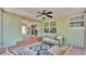 A covered patio with comfortable seating and a view of the living spaces at 4219 Forest Hills Dr, Lakeland, FL 33813