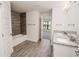 A bright bathroom featuring a tub shower combo with attractive wood-look tile at 5409 Waterside Dr, Auburndale, FL 33823