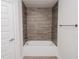 Bathroom showcasing a tub with gray wood-look tiles at 5409 Waterside Dr, Auburndale, FL 33823