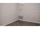 Elegant dining room featuring wood-look tile floors and decorative wall paneling at 5409 Waterside Dr, Auburndale, FL 33823