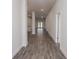 Bright hallway with wood-look tile floors that leads to other rooms in the house at 5409 Waterside Dr, Auburndale, FL 33823