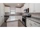 Beautiful kitchen with stainless steel appliances, granite countertops and white cabinets at 5409 Waterside Dr, Auburndale, FL 33823