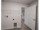 Well lit laundry room featuring tile floor and ample storage space at 5409 Waterside Dr, Auburndale, FL 33823