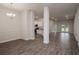 Open concept living space with kitchen, dining, and living areas with modern wood-look tile floors at 5409 Waterside Dr, Auburndale, FL 33823