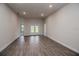Bright living room with wood-look tile floors and access to the backyard patio at 5409 Waterside Dr, Auburndale, FL 33823