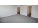 Main bedroom featuring neutral carpet and a doorway into an en-suite bath and walk-in closet at 5409 Waterside Dr, Auburndale, FL 33823