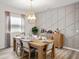 Inviting dining room with modern lighting, stylish wall decor, and seating for six at 557 Silver Course Radl, Ocala, FL 34472