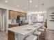 Spacious kitchen featuring a large island with seating, stainless steel appliances, and wooden cabinets at 557 Silver Course Radl, Ocala, FL 34472