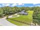 Aerial view of home with a circular driveway and second structure on expansive treed lot at 59 Jimmy Lee Rd, Winter Haven, FL 33880