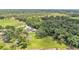 Aerial view showcases a well-maintained home surrounded by lush greenery and mature trees at 59 Jimmy Lee Rd, Winter Haven, FL 33880