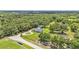 Overhead view of home with circular drive and additional structure surrounded by lush landscape and privacy at 59 Jimmy Lee Rd, Winter Haven, FL 33880