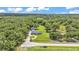 Expansive aerial view of the property showcasing the home, additional structure and green landscape at 59 Jimmy Lee Rd, Winter Haven, FL 33880