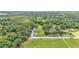 Aerial view displays home with large yard and mature trees in neighborhood at 59 Jimmy Lee Rd, Winter Haven, FL 33880