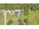 Aerial view of the home and outbuilding on a large lot surrounded by trees at 59 Jimmy Lee Rd, Winter Haven, FL 33880