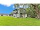 The backyard of the home features a detached garage with a second story deck at 59 Jimmy Lee Rd, Winter Haven, FL 33880