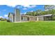 Well-maintained backyard with a lush green lawn, patio area, and covered structure at 59 Jimmy Lee Rd, Winter Haven, FL 33880