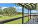 Expansive backyard view from a charming covered balcony, perfect for enjoying the outdoors at 59 Jimmy Lee Rd, Winter Haven, FL 33880