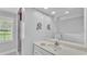 Bathroom features double mirrors, a large vanity with sink, and tiled shower with window to outside at 59 Jimmy Lee Rd, Winter Haven, FL 33880