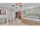 Large bathroom with separate tub, vanity, and toilet, with tile flooring and a large window at 59 Jimmy Lee Rd, Winter Haven, FL 33880