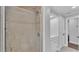 Tiled shower is showcased along with partial view of the vanity in this bright and updated bathroom at 59 Jimmy Lee Rd, Winter Haven, FL 33880