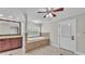 Bright bathroom features a window-side tub with cherry vanity and tiled surround at 59 Jimmy Lee Rd, Winter Haven, FL 33880